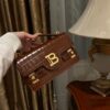 Balmain B-Buzz 24 monogrammed grained leather bag red brown