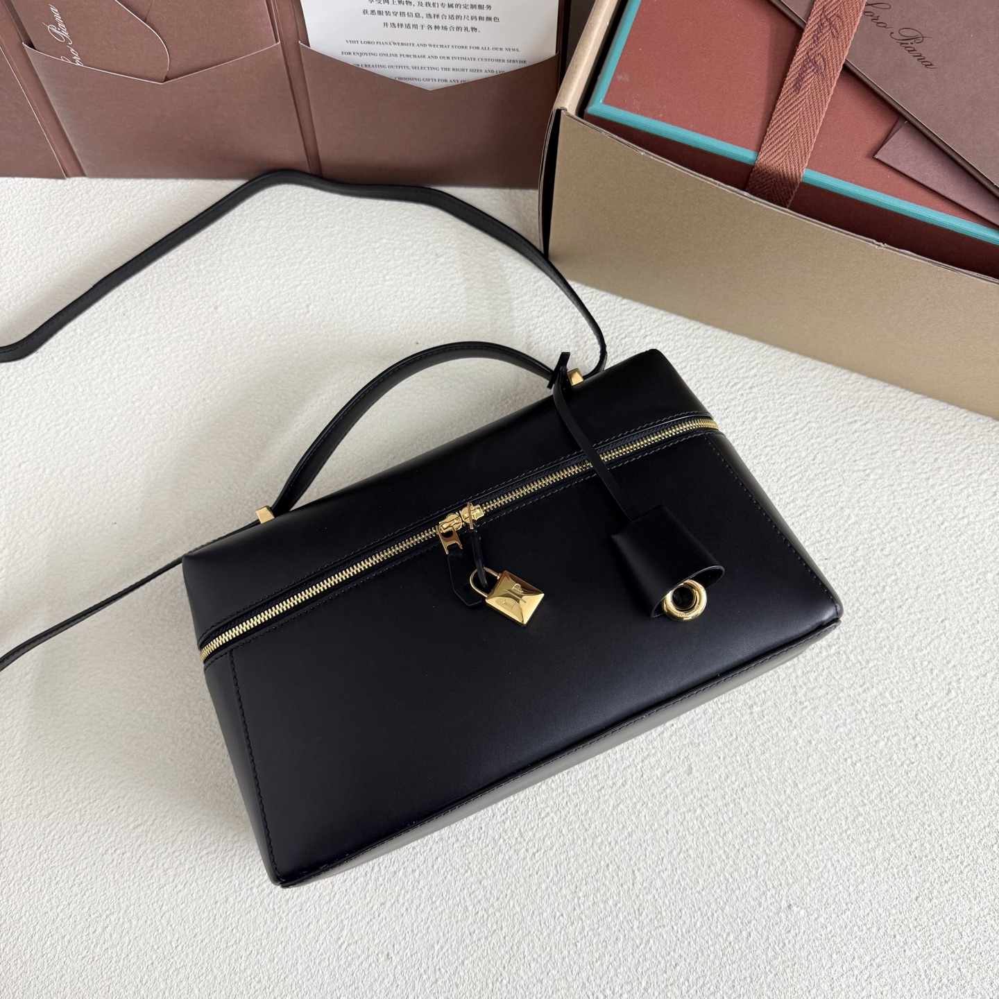 Extra L27 leather crossbody bag in black - Loro Piana |